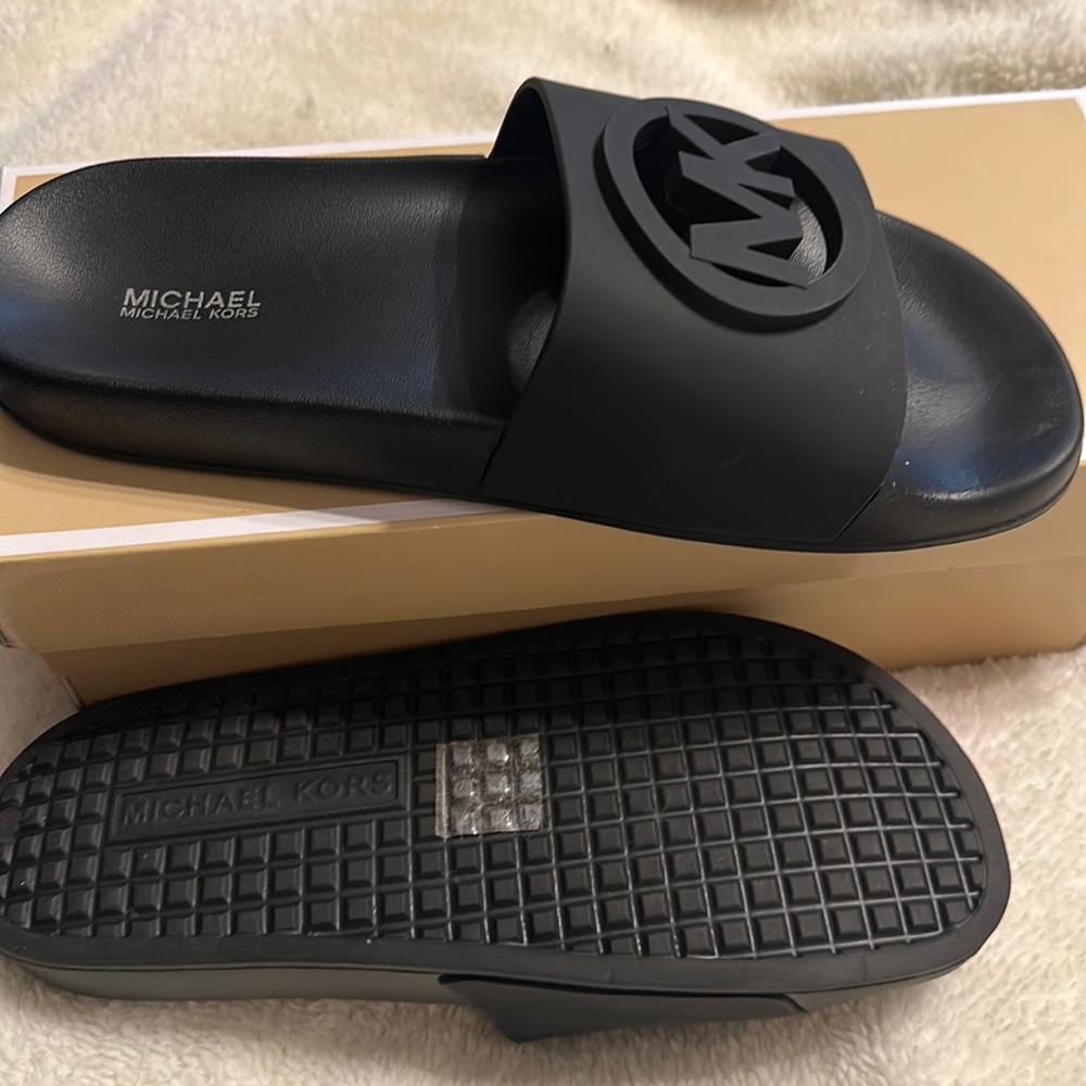 Black Michael Kors slides.